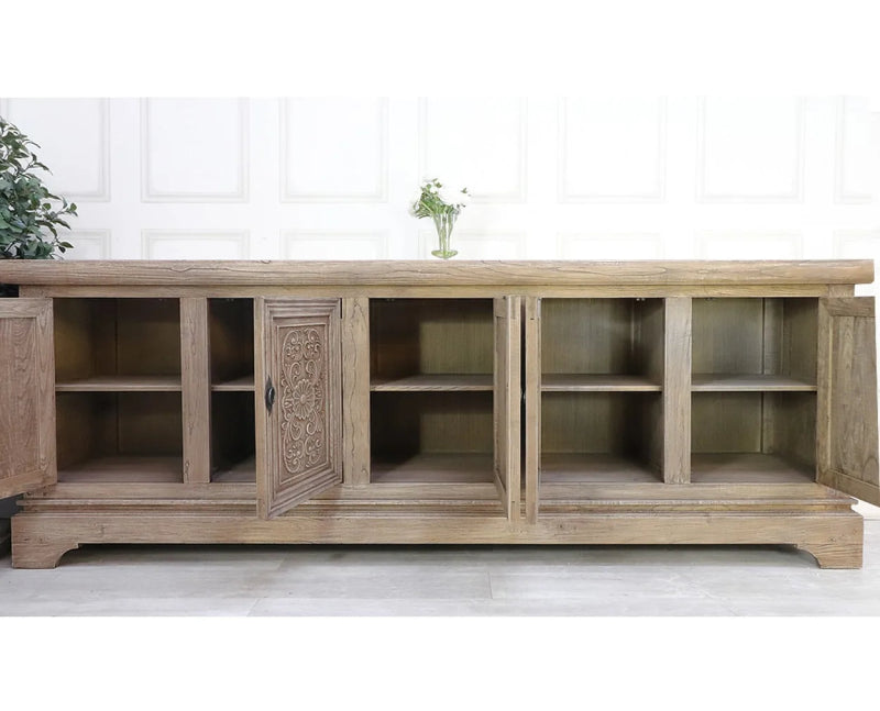 Carved wood server in a detail view showing recessed door panels and a light, weathered-looking finish