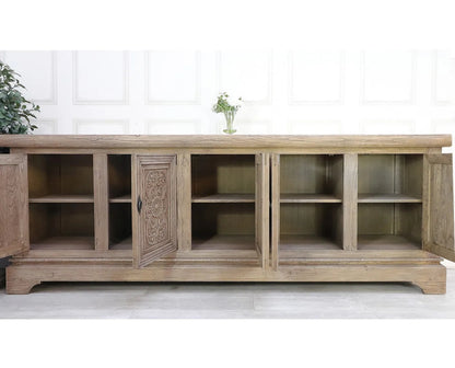Carved wood server in a detail view showing recessed door panels and a light, weathered-looking finish