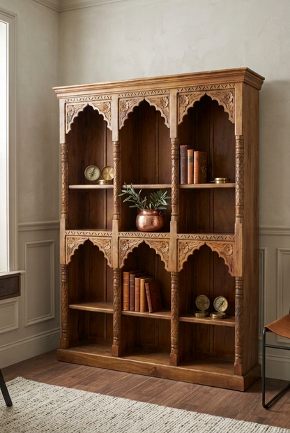 Rustic triple arch bookcase in solid wood, styled in living room with books, small clocks and a copper-colored planter.
