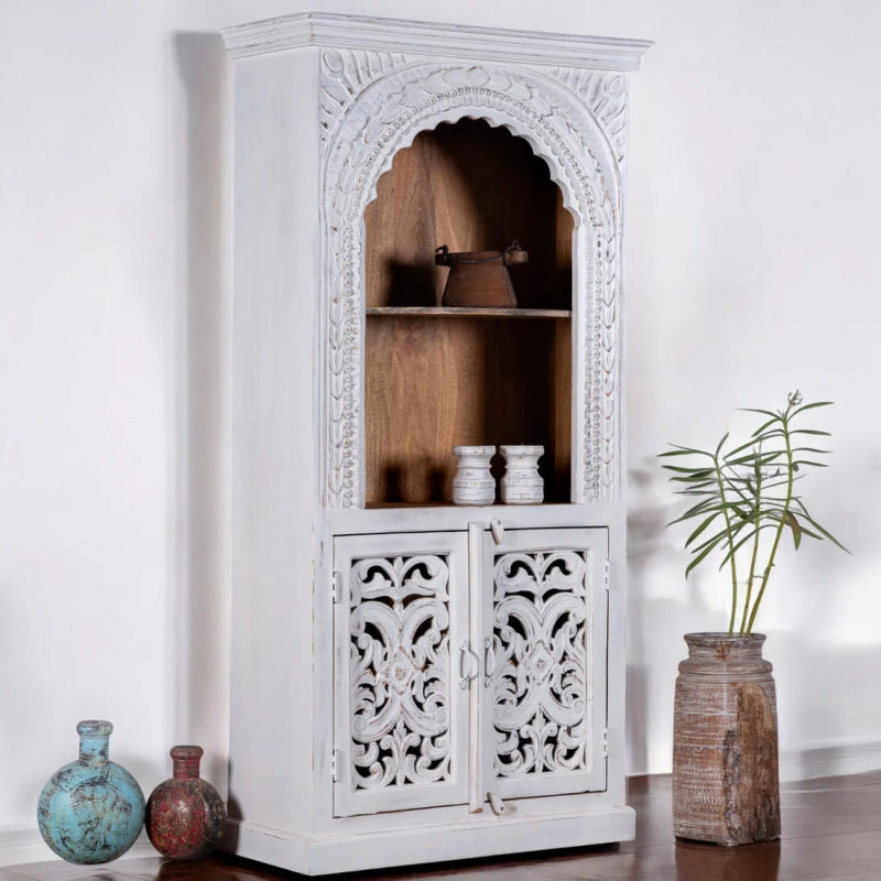 Rustic two-door bookcase in solid wood, side profile view at an angle showing the plain side and carved front.