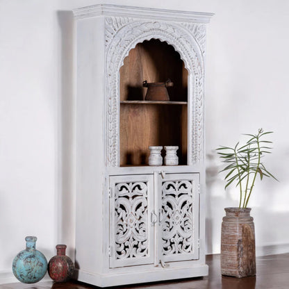Rustic two-door bookcase in solid wood, side profile view at an angle showing the plain side and carved front.
