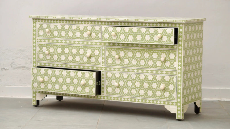 Sage green bone inlay dresser with one open drawer showing interior, floral honeycomb pattern and round knobs