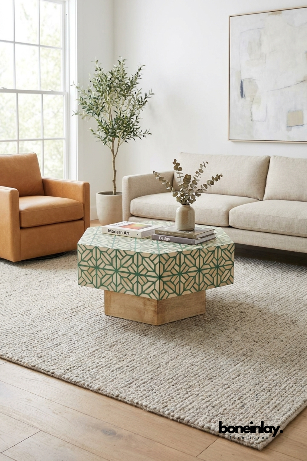 Sage green geometric bone inlay hexagon coffee table with wooden base, styled in a modern living room with neutral sofa and armchair