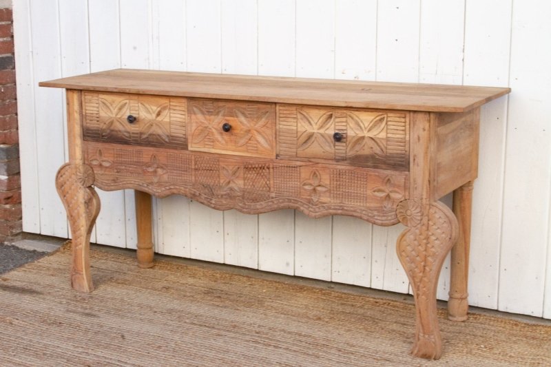 Scalloped Apron Entryway Table in rustic solid wood, side profile view showing the drawer fronts and curved legs.