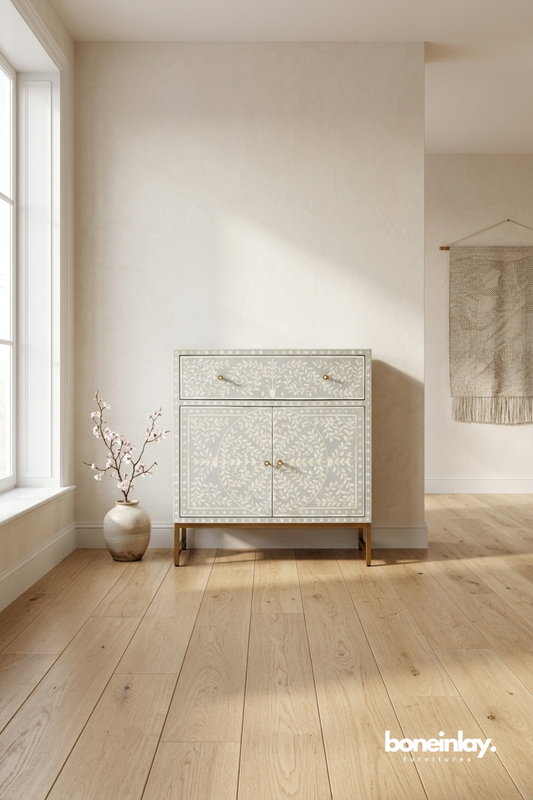 Bone inlay accent cabinet with floral vine pattern, brass legs and double door storage.