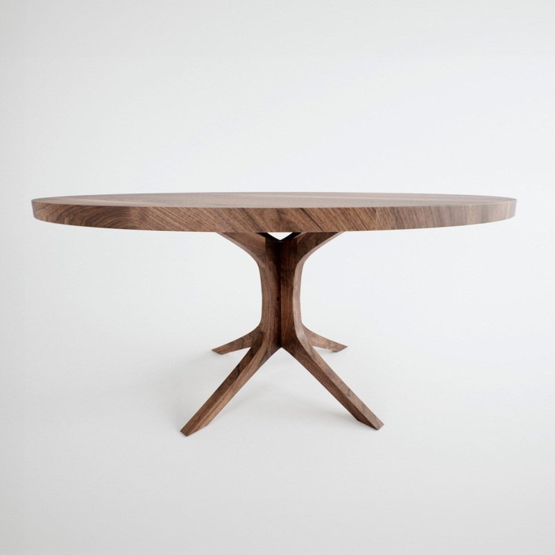 Modern round dining table made of solid wood with a rich natural finish and a unique architectural branched pedestal base against a white background.