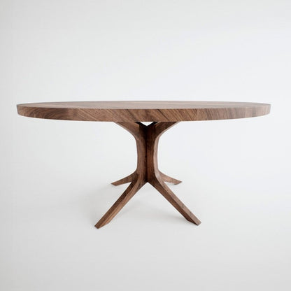 Modern round dining table made of solid wood with a rich natural finish and a unique architectural branched pedestal base against a white background.
