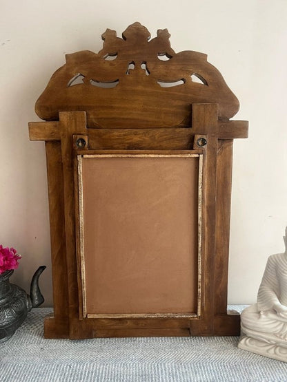 Solid Wood Decorative Mirror, back view showing the brown wooden frame, rectangular backing panel and hanging rings.