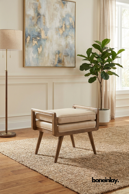 Mid-century modern upholstered accent stool with curved walnut wood frame, cream cushioned seat and minimalist contemporary design.