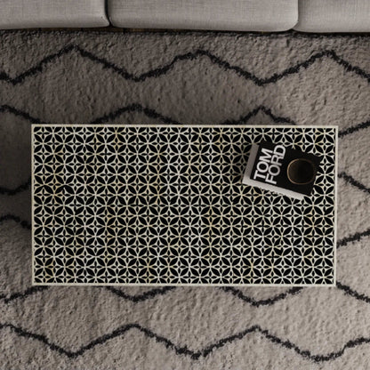 Overhead view of stellar monochrome bone inlay coffee table displaying full black and white geometric star-cross inlay pattern across the surface.