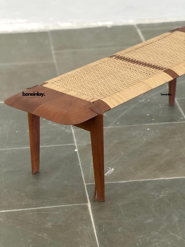Teak wood rattan bench combining a sculptural frame, woven cane seat, and natural minimalist design.