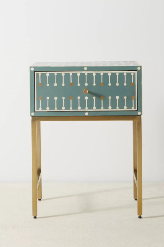Teal handmade bone inlay bedside table with single drawer open, featuring white and gold geometric dot-dash inlay pattern and slim brushed brass metal legs.