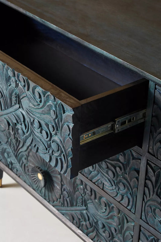 Close-up of an open drawer on the Gulliver wood bureau, showing the drawer interior beside its carved front.
