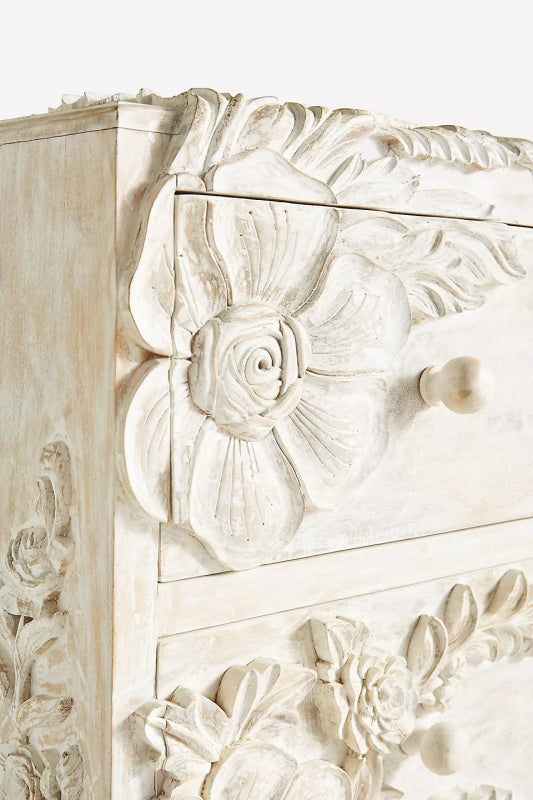 Three-Drawer Whitewash Credenza close-up of the top drawer corner, showing a round wood knob beside carved roses.