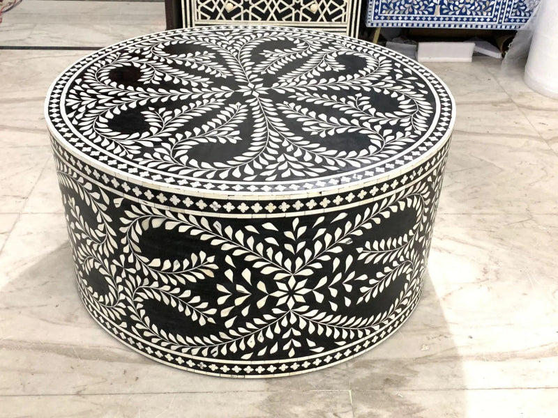 Traditional black and white bone inlay drum coffee table with dense vine and leaf mosaic pattern on cylindrical base and radiating floral medallion design on round tabletop.