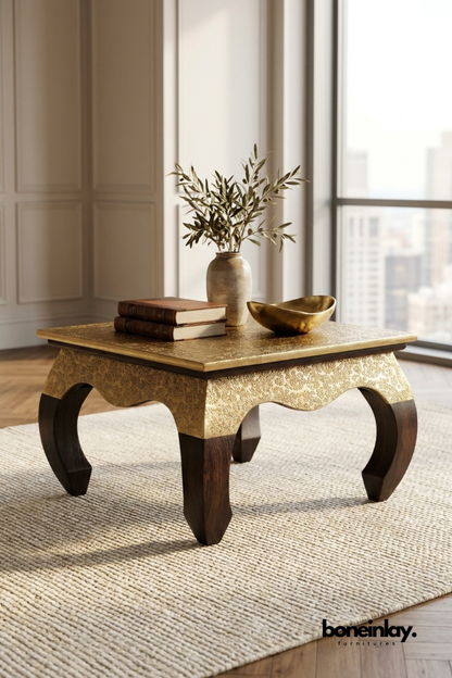 Gold embossed Accent Table with carved detailing and dark wooden curved legs in a modern interior setting