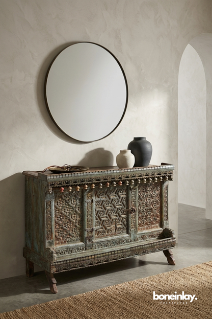 Antique carved wooden cabinet with distressed finish and handcrafted geometric panel detailing
