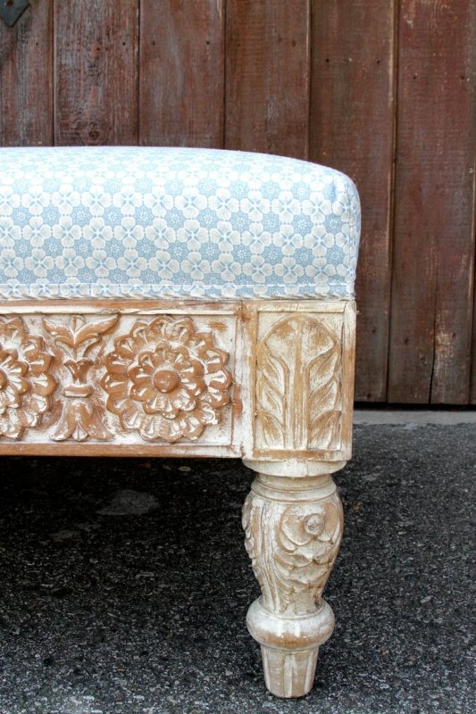 Turned leg wood bench in rustic finish, close-up of leg showing carved rosettes beneath a floral corner block.
