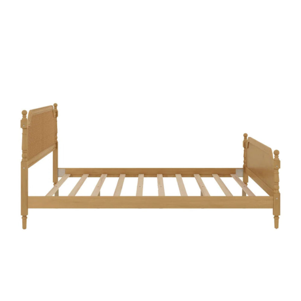 Turned post rattan bed in side profile view, showing the long side rail, exposed slats and different panel heights.