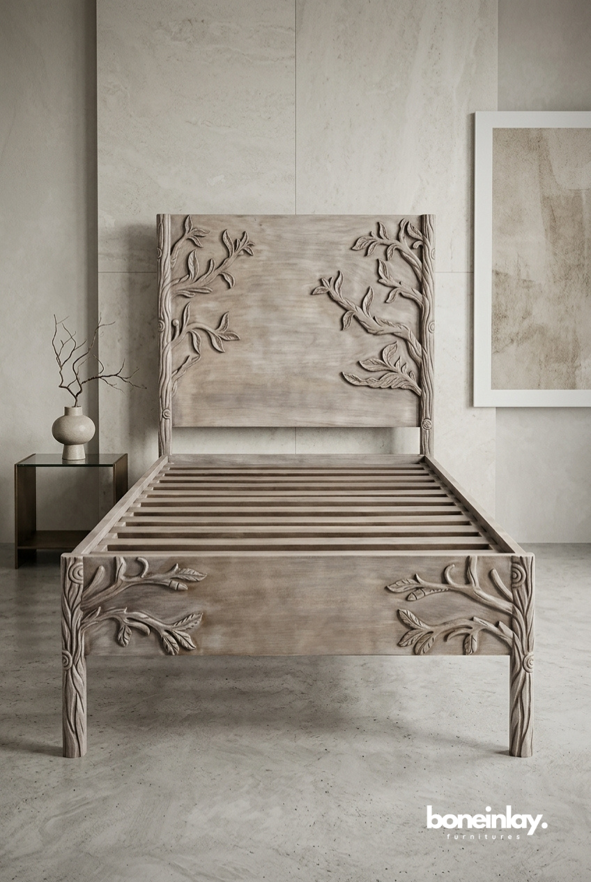 Twin-sized hand-carved solid wood bed frame featuring high-relief branch and leaf carvings on the headboard and footboard in a light natural finish.