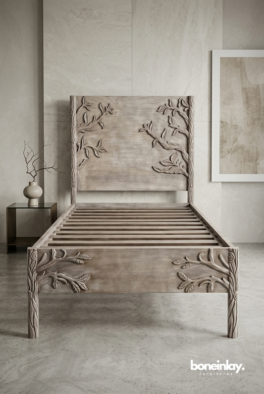 Twin-sized hand-carved solid wood bed frame featuring high-relief branch and leaf carvings on the headboard and footboard in a light natural finish.