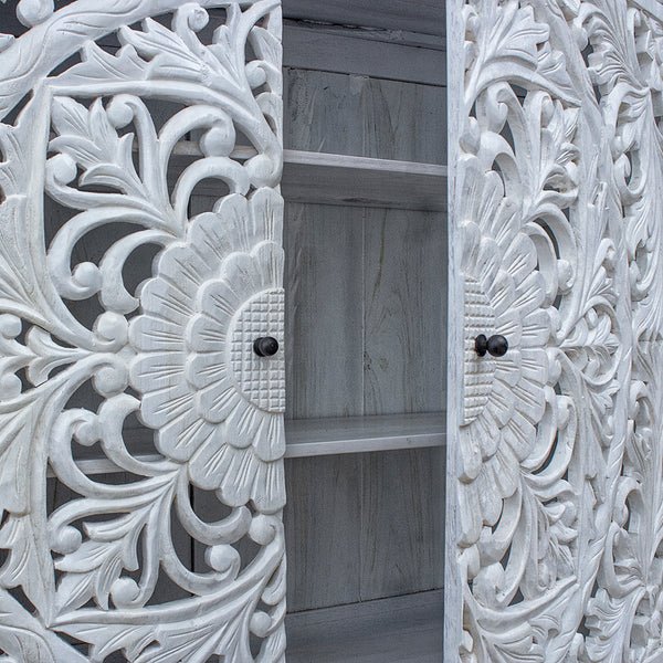 Two door carved sideboard in rustic wood, open door view revealing interior shelves and floral carvings.