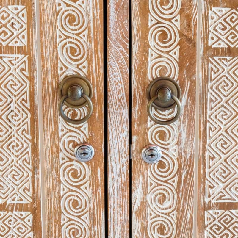 Two door carved wardrobe cabinet in natural wood, front view displaying the carved doors and frame detail.