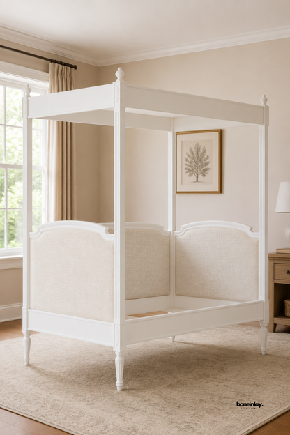 Handcrafted white wooden four-poster canopy bed featuring elegant fluted posts and upholstered curved headboard and footboard panels. This luxury statement bed brings classic British bedroom elegance and timeless artisan design to modern UK interiors.