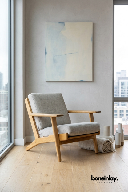 Modern lounge chair wood frame, and soft grey upholstered cushions for contemporary living room seating.