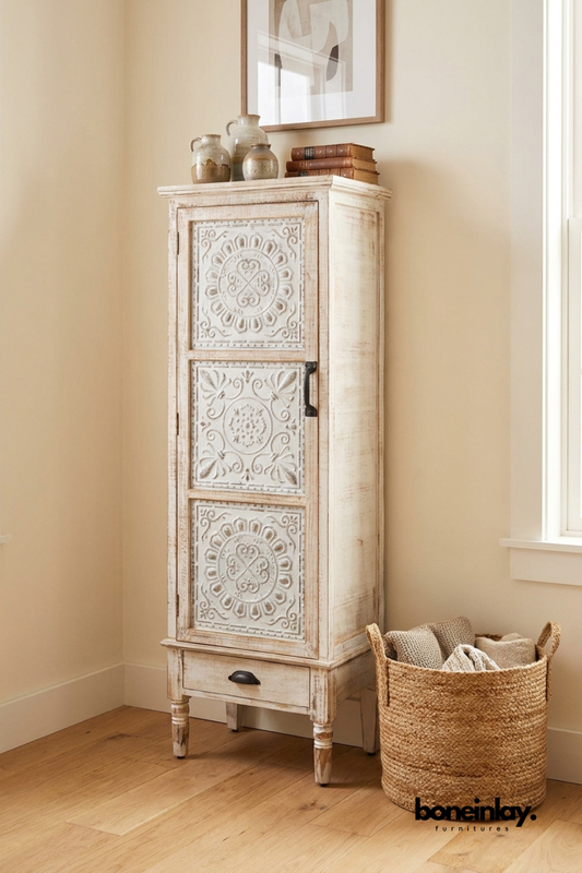 Distressed white carved solid wood tall storage cabinet featuring hand carved floral door panels, single drawer, spacious interior shelving, and rustic farmhouse accent furniture.