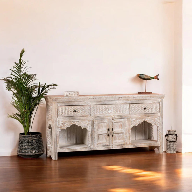 Whitewashed Carved Buffet in solid wood, styled in a living room with scalloped arches and drawers across the top.