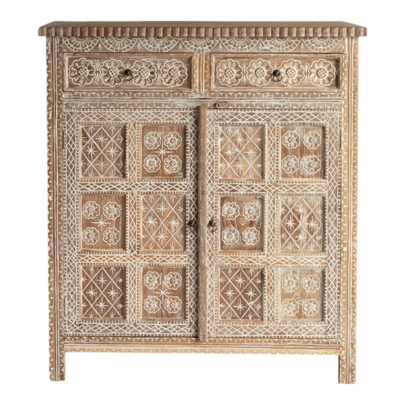 Whitewashed wooden cupboard with floral relief carvings, shown in a front view with two upper drawers and paneled doors.