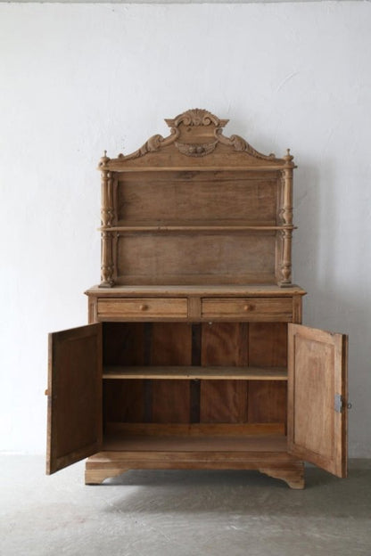 Wooden shelf and cabinet hutch with a shaped crown and lower doors, front view in a dim gallery thumbnail.