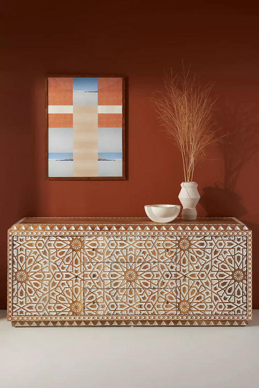 Large solid wood Albaron buffet featuring hand-carved starburst and geometric lattice patterns in a natural and white finish.