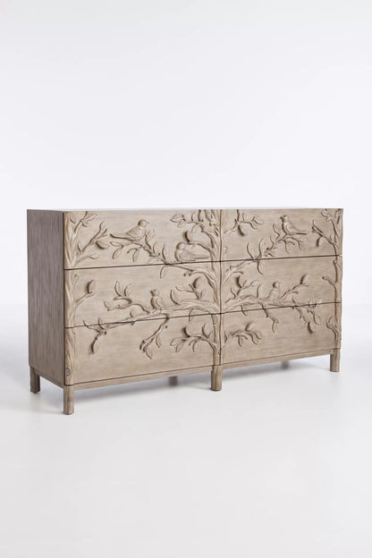 Close-up of hand-carved bird perched on branch motif on drawer front of Ornithology solid wood six drawer dresser