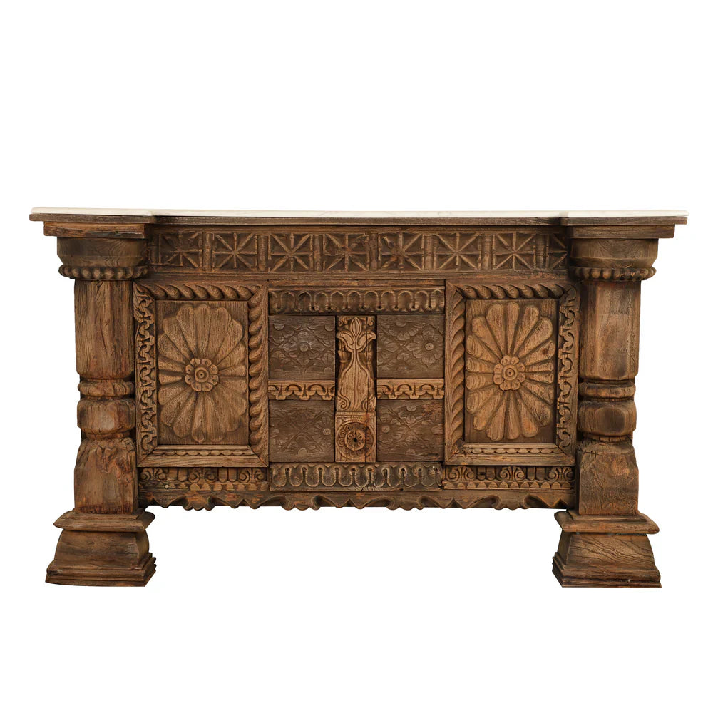  Antique brown wooden credenza with carved floral panels, geometric trim, and chunky column legs, shown from the front.