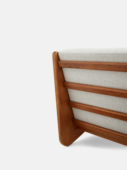 Solid wood accent chair with a modern geometric profile, armless construction, and light neutral fabric.