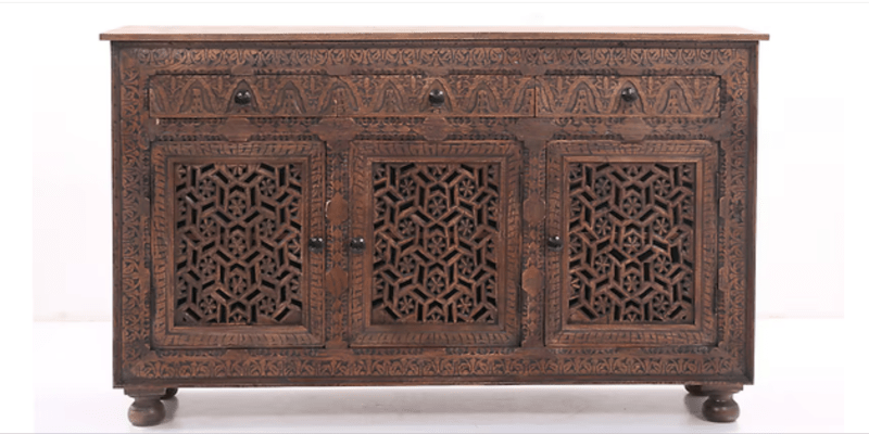 Front view of a solid wood Indian sideboard featuring three drawers and three doors with intricate hand-carved Jali geometric fretwork in a dark brown finish.