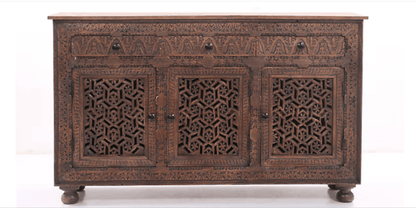 Front view of a solid wood Indian sideboard featuring three drawers and three doors with intricate hand-carved Jali geometric fretwork in a dark brown finish.