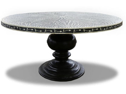  Black round bone inlay dining table with an ivory leaf-patterned top and sculpted pedestal base.