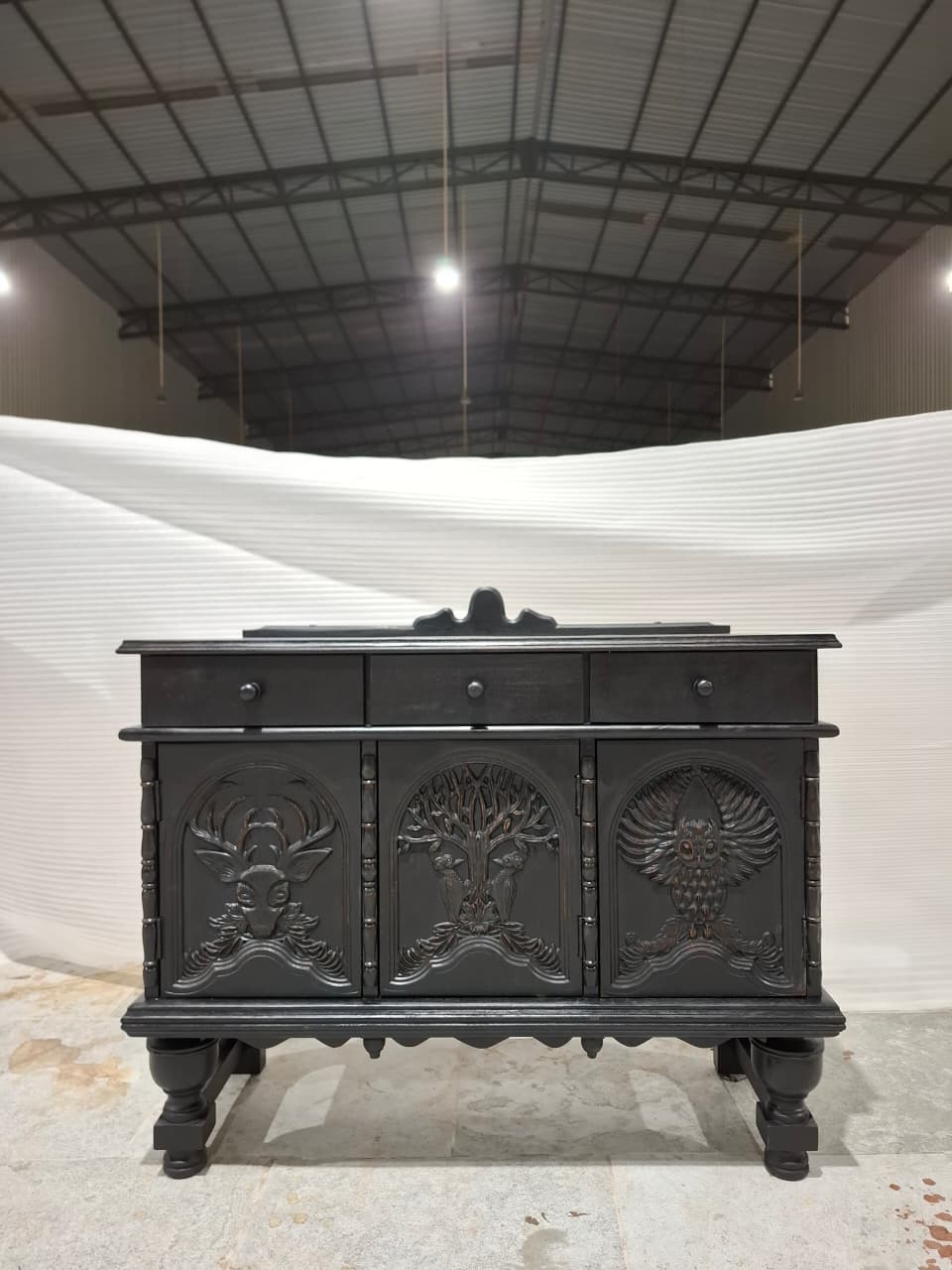 black small credenza with whimsical design