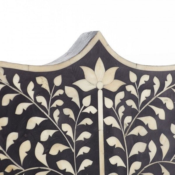 Close-up of scalloped arch top on black bone inlay Mehrab headboard with white lotus and trailing vine inlay detail