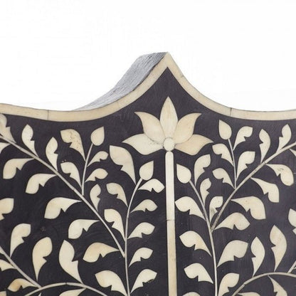 Close-up of scalloped arch top on black bone inlay Mehrab headboard with white lotus and trailing vine inlay detail