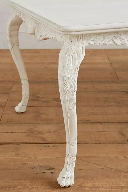 close up of hand carved menagerie dining table legs