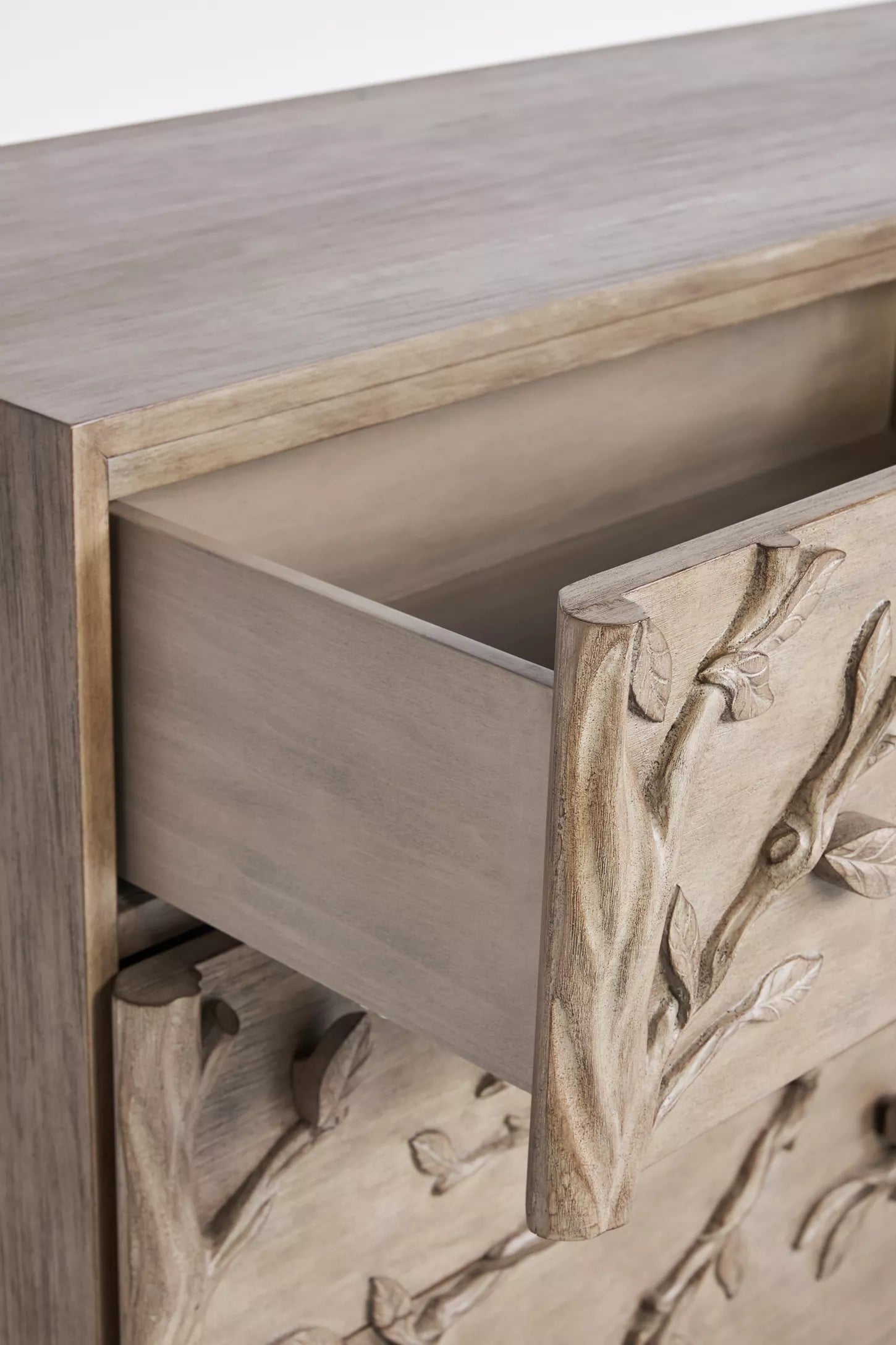 Ornithology six drawer dresser styled in luxury master bedroom with bird branch carving and natural wood finish