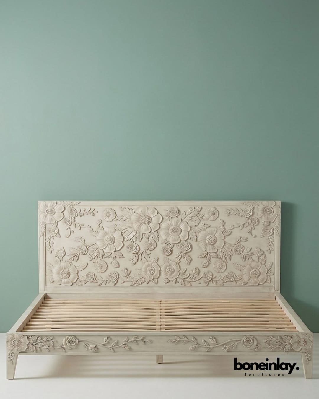 Luxury wooden bed frame with a detailed botanical carved headboard, part of the enchantment collection.