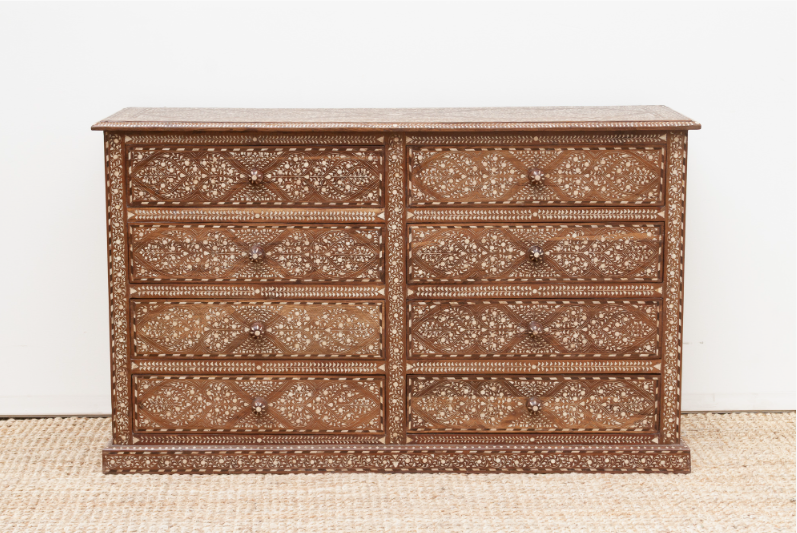 Floral wood inlay chest with eight closed drawers and a patterned plinth base, displayed on a woven rug.