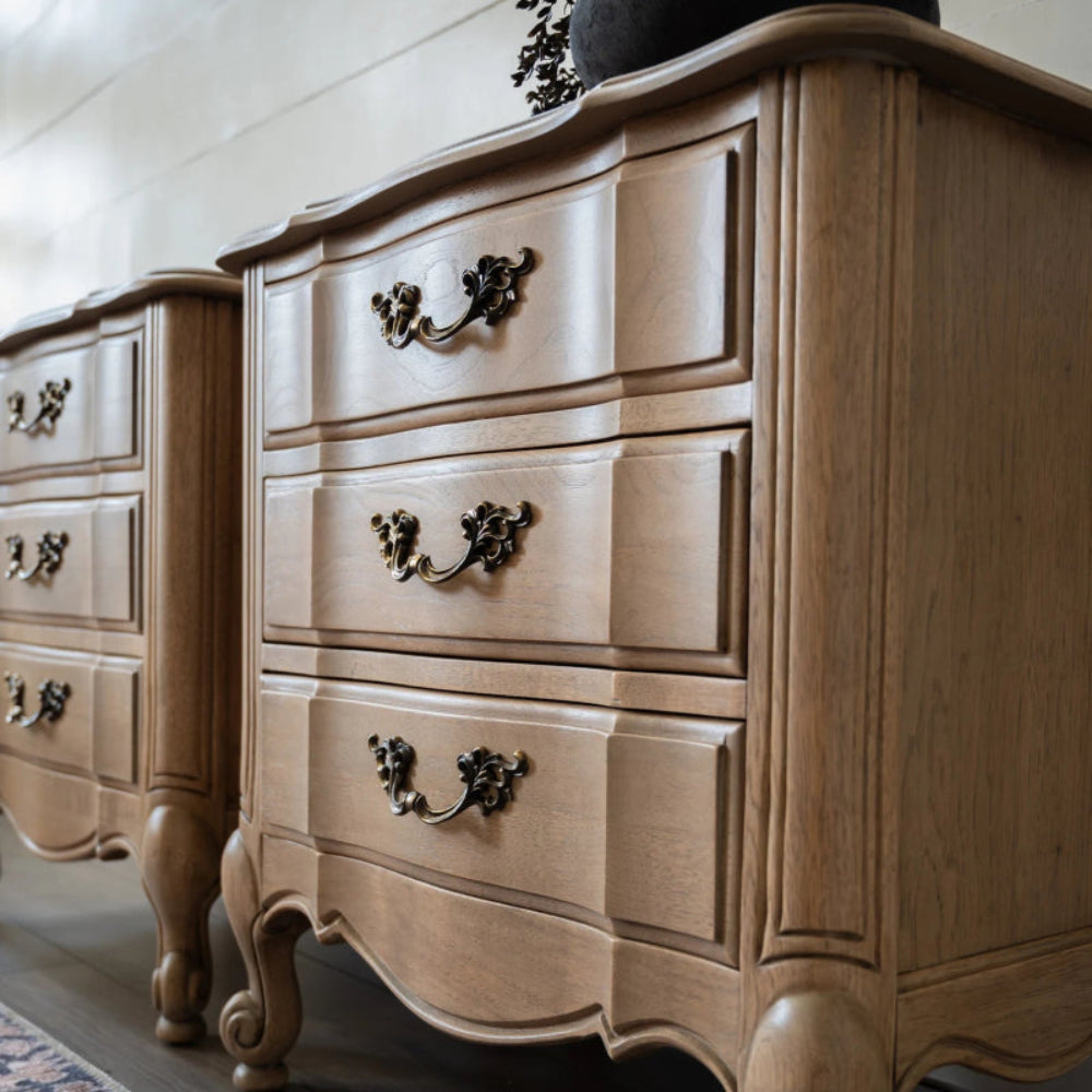 Scalloped edge wood nightstand in deep brown tone, close-up of drawer handle detail.
