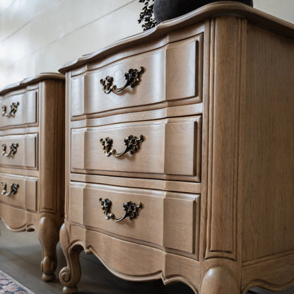 Scalloped edge wood nightstand in deep brown tone, close-up of drawer handle detail.