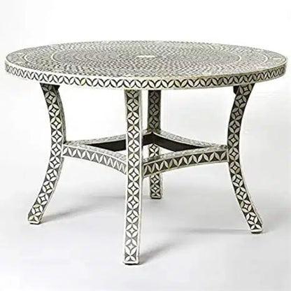 Gray and ivory bone inlay round dining table with a floral tabletop, four curved legs, and patterned cross supports.